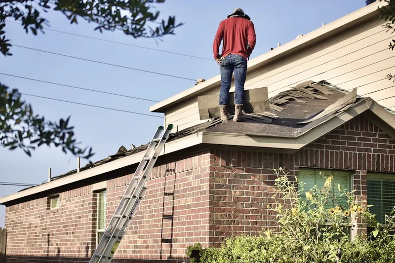Professional roofer working on a residential roof in Diamondville